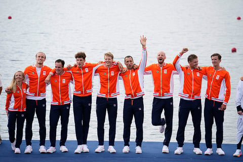 Men's eight rowing final: Netherlands' team pose after winning Silver